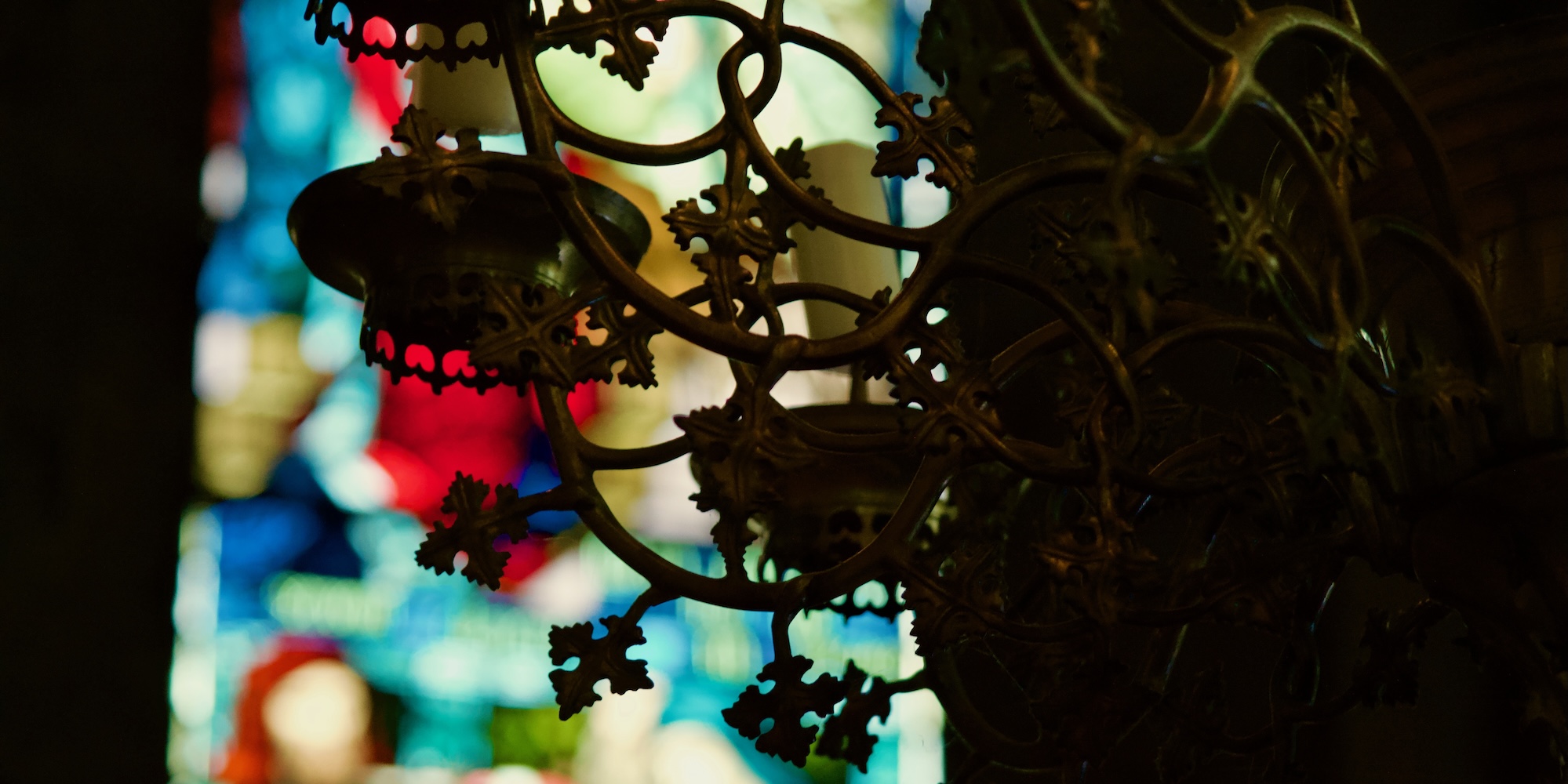 The chandelier presented to Brechin Cathedral in 1615 by Bishop Lamb with the cathedral chance's stained glass in the background.