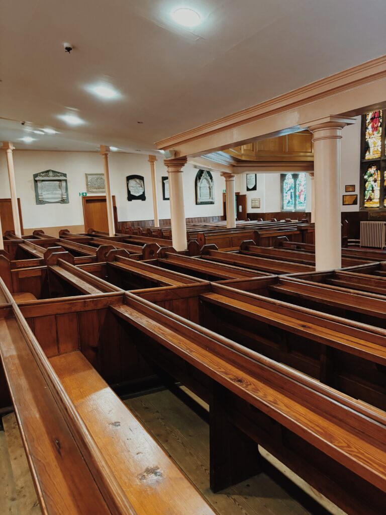 Rows of wooden pews in the church