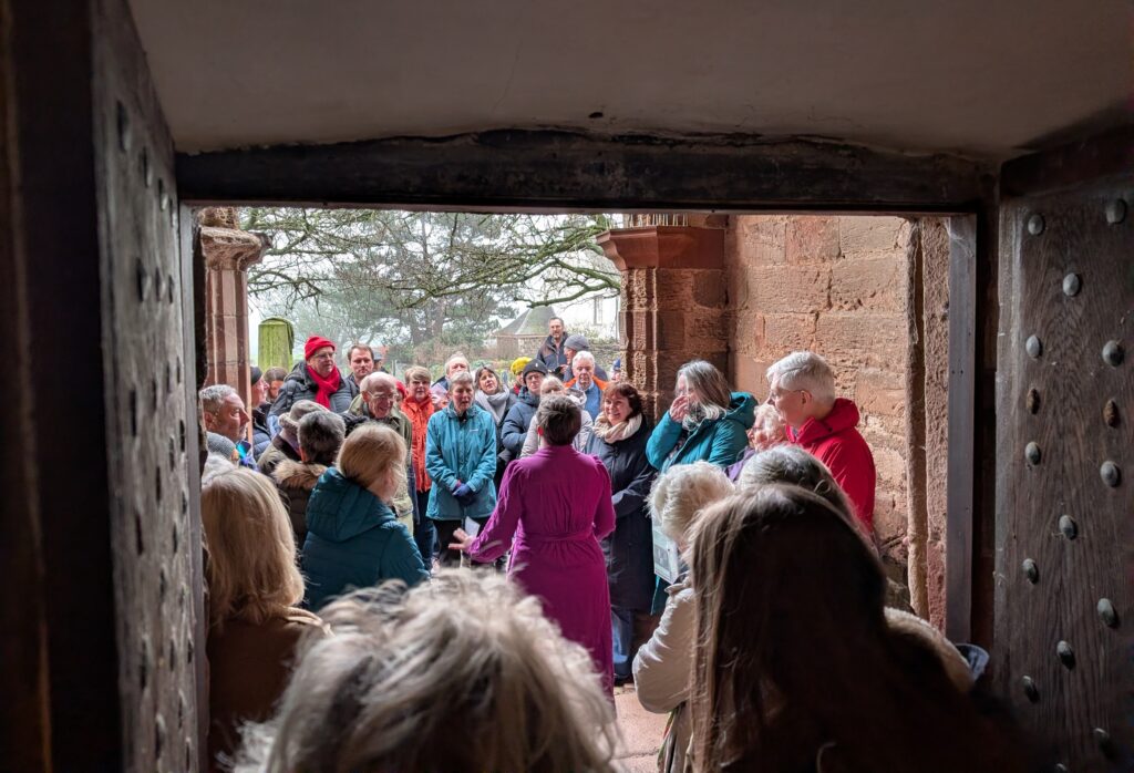 crowd at the porch of Whitekirk, looking towards Lizzie leading the tour