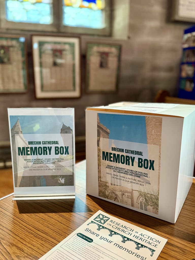 Memory box sat on a table at Brechin church with signage to share your memories